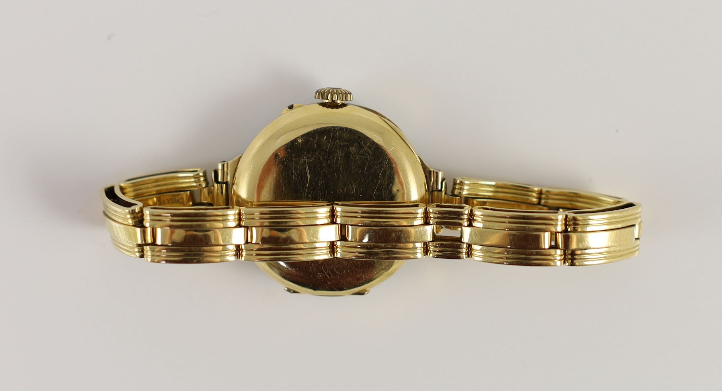 A lady's early to mid 20th century 18ct gold, enamel and diamond chip set manual wind wrist watch